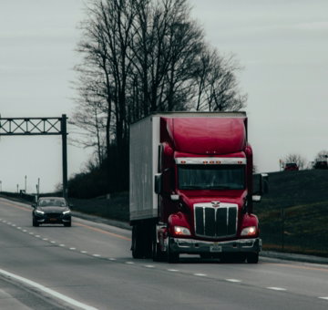red and white truck on road during daytime