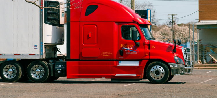 red and white truck on road during daytime