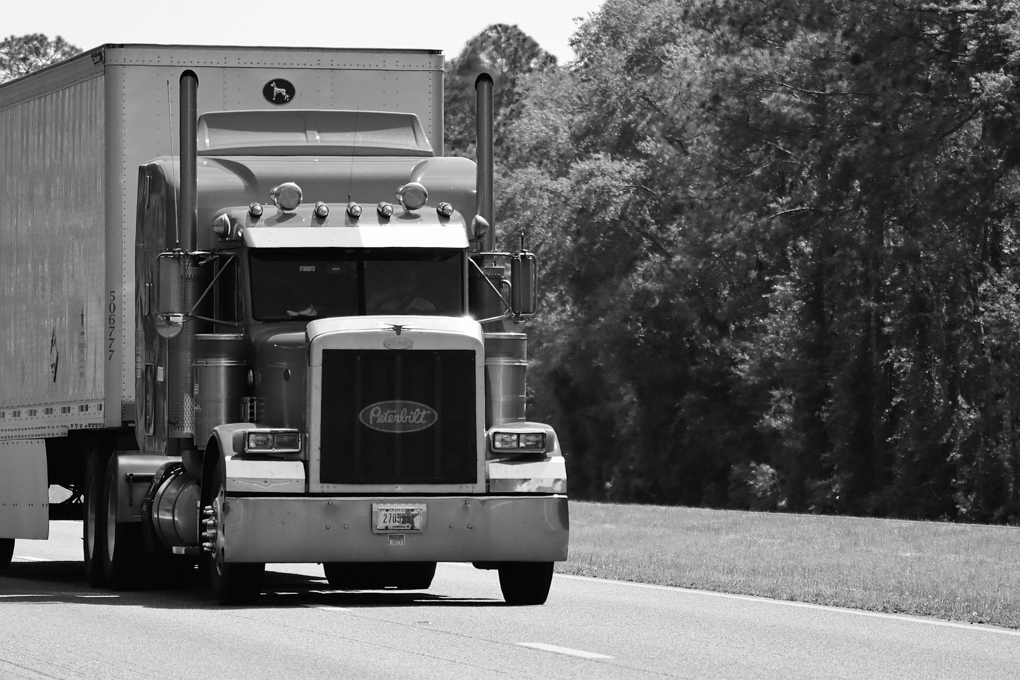 a black and white photo of a semi truck